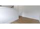 Hallway with hardwood floors, white walls, and white trim, leading to a door at 751 Switchyard Pl, Indianapolis, IN 46202