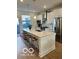 Modern kitchen with white cabinets, stainless steel appliances, and a spacious island with seating at 751 Switchyard Pl, Indianapolis, IN 46202