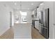 A stunning white kitchen with stainless steel appliances and a center island with marble countertop at 751 Switchyard Pl, Indianapolis, IN 46202