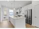 A stunning white kitchen with stainless steel appliances and a center island with marble countertop at 751 Switchyard Pl, Indianapolis, IN 46202