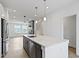 Open concept kitchen with island, stainless steel appliances, and pendant lighting overlooking the adjacent living space at 751 Switchyard Pl, Indianapolis, IN 46202