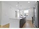 A stunning gray and white kitchen with stainless steel appliances and a center island with marble countertop at 751 Switchyard Pl, Indianapolis, IN 46202