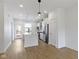 Modern kitchen with stainless steel appliances, white cabinets, and a marble island, adjacent to an outdoor patio at 751 Switchyard Pl, Indianapolis, IN 46202