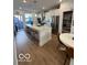 Bright kitchen with stainless steel appliances, white cabinetry, a large island and room for dining at 751 Switchyard Pl, Indianapolis, IN 46202
