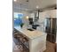 Modern kitchen with a large island, stainless steel appliances, and sleek white cabinetry at 751 Switchyard Pl, Indianapolis, IN 46202