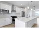 Bright, modern kitchen featuring white cabinetry, stainless steel appliances, and a large marble-top island at 751 Switchyard Pl, Indianapolis, IN 46202