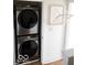 Convenient laundry area with stacked washer and dryer and a folding drying rack at 751 Switchyard Pl, Indianapolis, IN 46202