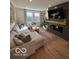 Inviting living room featuring a comfortable sectional sofa and a modern fireplace with a mounted television at 751 Switchyard Pl, Indianapolis, IN 46202