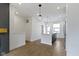 Open concept living space with hardwood floors and a view of the kitchen and dining area at 751 Switchyard Pl, Indianapolis, IN 46202