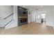 Modern living area showcasing hardwood floors, fireplace, open staircase and a view into the kitchen at 751 Switchyard Pl, Indianapolis, IN 46202