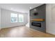 Bright living room features an electric fireplace with a wood mantle and large windows at 751 Switchyard Pl, Indianapolis, IN 46202