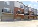 Street view of modern townhomes with private balconies and gray garage doors at 751 Switchyard Pl, Indianapolis, IN 46202