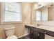 This well-lit bathroom offers tile floor, a dark vanity, and an integrated sink at 8015 Ridgegate East Dr, Indianapolis, IN 46268