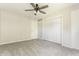 This bedroom features neutral walls, carpet floor, a ceiling fan, and a double closet at 8015 Ridgegate East Dr, Indianapolis, IN 46268