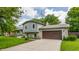 Charming two-story home featuring a stone facade, attached two-car garage, and well-maintained landscaping at 8015 Ridgegate East Dr, Indianapolis, IN 46268