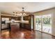 Modern kitchen with dark wood cabinets, stainless steel appliances, and a sliding door to the backyard at 8015 Ridgegate East Dr, Indianapolis, IN 46268
