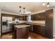 Updated kitchen features dark cabinets, stainless steel appliances, granite countertops, and a center island at 8015 Ridgegate East Dr, Indianapolis, IN 46268