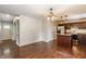 Open-concept view into the kitchen with dark hardwood floors, island and stainless steel appliances at 8015 Ridgegate East Dr, Indianapolis, IN 46268