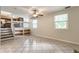 The additional living area features tile floor, a ceiling fan, and open stairs to the kitchen at 8015 Ridgegate East Dr, Indianapolis, IN 46268