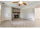 The spacious living room boasts a stone fireplace, tile floor, and an exterior door at 8015 Ridgegate East Dr, Indianapolis, IN 46268