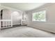 Bright living room with soft carpet, a large window, and views to other spaces in the home at 8015 Ridgegate East Dr, Indianapolis, IN 46268