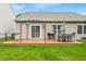 Spacious backyard featuring a wooden deck with outdoor seating, a grill, and green lawn at 8315 Exton Rd, Indianapolis, IN 46239