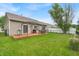 Lush backyard featuring a wooden deck, outdoor seating, grill, and vibrant green grass at 8315 Exton Rd, Indianapolis, IN 46239