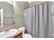 Standard bathroom features a vanity, toilet, and shower with a gray curtain at 8315 Exton Rd, Indianapolis, IN 46239