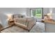 Bright bedroom with a large window, plush bed, rocking chair, and stylish decor at 8315 Exton Rd, Indianapolis, IN 46239