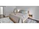 A well lit bedroom showcases a plush bed with decorative pillows and a stylish rug at 8315 Exton Rd, Indianapolis, IN 46239