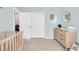 Bedroom with a changing table and dresser, closet, and ample floor space at 8315 Exton Rd, Indianapolis, IN 46239