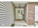 Inviting entryway features a brick accent wall and a decorative 'WELCOME' sign enhancing the cozy ambiance at 8315 Exton Rd, Indianapolis, IN 46239