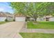 This home features a brick and vinyl exterior, a well-manicured lawn, and a two-car garage at 8315 Exton Rd, Indianapolis, IN 46239