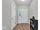 Bright foyer with wood-look flooring, a sidelight window, and white doors offering a warm welcome at 8315 Exton Rd, Indianapolis, IN 46239