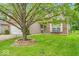 Charming single-story home with well-manicured lawn, mature shade tree, and inviting brick accents at 8315 Exton Rd, Indianapolis, IN 46239
