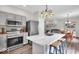 Open-concept kitchen with stainless appliances, island, connected to the dining and living areas at 8315 Exton Rd, Indianapolis, IN 46239