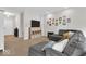 Spacious living room featuring plush carpeting, ample natural light, and a stylish sectional sofa at 8315 Exton Rd, Indianapolis, IN 46239