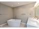 This bathroom features a soaking tub, double vanity, and modern fixtures at 8955 Stonegate Rd # A, Indianapolis, IN 46227