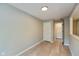 Neutral bedroom featuring wood-look flooring, light gray walls and convenient access to the home's hallways at 8955 Stonegate Rd # A, Indianapolis, IN 46227