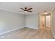 Large bedroom featuring wood-look flooring, ceiling fan, and bathroom access at 8955 Stonegate Rd # A, Indianapolis, IN 46227
