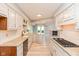 Modern kitchen boasts granite counters, stainless appliances, and a view of the living area at 8955 Stonegate Rd # A, Indianapolis, IN 46227