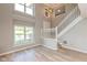 The living room has new vinyl flooring, a staircase, and lots of light at 8955 Stonegate Rd # A, Indianapolis, IN 46227