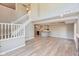 Open living area with staircase and bar that leads into the kitchen at 8955 Stonegate Rd # A, Indianapolis, IN 46227