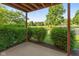 Private covered patio area with mature landscaping and an inviting outdoor space for relaxing or entertaining at 8955 Stonegate Rd # A, Indianapolis, IN 46227