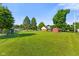Spacious backyard with mature trees, a shed, and a well-kept lawn at 1010 Maple St, Greenwood, IN 46142