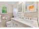 Bright bathroom with double sinks, and a window providing natural light at 1010 Maple St, Greenwood, IN 46142