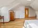 Attic bedroom featuring hardwood floors, large closet, and natural light at 1010 Maple St, Greenwood, IN 46142