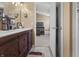 Bathroom featuring a double vanity with modern fixtures, toilet, and doorway to the bedroom at 10312 Gladeview Dr, Indianapolis, IN 46239