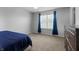 Bright bedroom with carpet, dark wood dresser, and large window at 10312 Gladeview Dr, Indianapolis, IN 46239