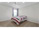 Bedroom featuring carpet, a ceiling fan, and a window with blue curtains at 10312 Gladeview Dr, Indianapolis, IN 46239